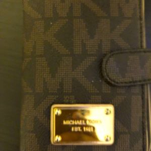 2 Michael Kors MK wallets, one camel colored and MK signature color.